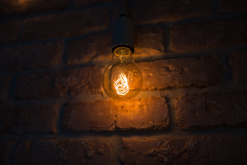 Light bulbs lamps on dark red brick background