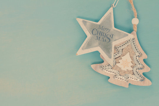 Blue and white christmas with star and christmas tree on blue wooden background, retro toned