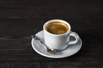 cup of aroma black espresso on wooden table