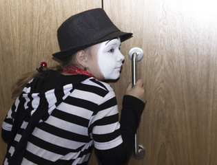 Girl as mime actress listening at the door