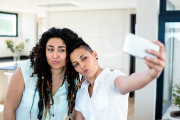 Lesbian couple taking a selfie on phone