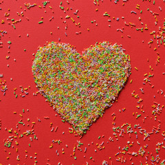 Heart shape made of multicolored candy sprinkles - Modern minima