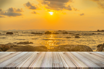 Fototapeta na wymiar Empty wooden table or shelf wall with sunset or sunrise on sand