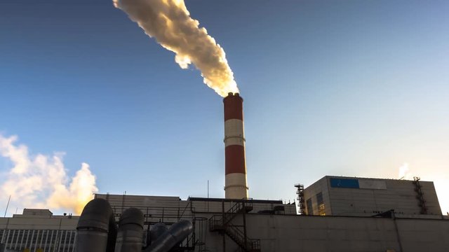 power plant emitting smoke and vapor in cold weather, time lapse
