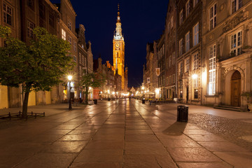 Deserted street at night in a classic medieval town in Europe with a clock tower 