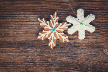 gingerbread christmas iced snowflakes cookies on wooden background, retro toned