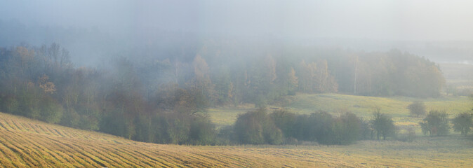 misty autumn morning over the valley, hunting tower on the edge