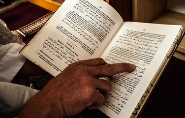 Naklejka premium Reading the Holy Quran in English at a mosque in Australia
