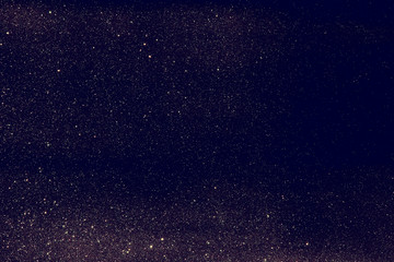 glitter vintage lights background. dark gold and black