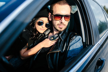 Portrait of young beautiful couple in the car