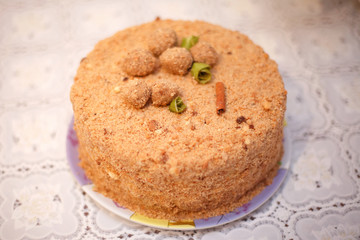 Beige round cake with cinnamon, close-up, selective focus