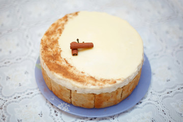 Beige round cake with cinnamon, close-up, selective focus