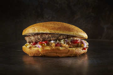 Big meat pie with beef and lots of filling. Dark metal background. Space.