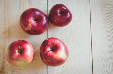 Fresh organic apples on rustic wooden background.