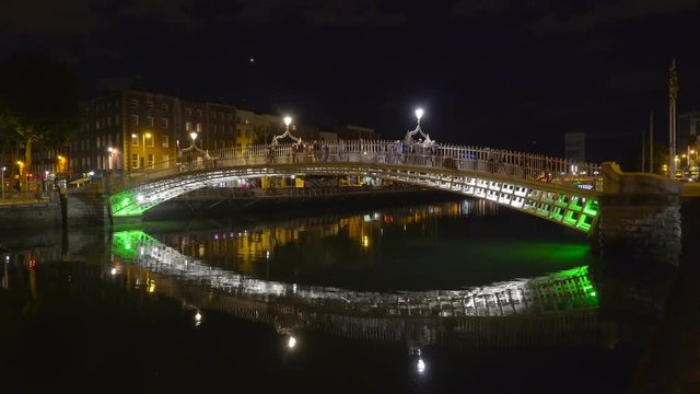 The beautiful city of Dublin taken at night with the bridge reflecting on the river water in Ireland