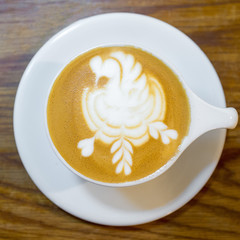 Latte art by a professional barista from a top-down view.