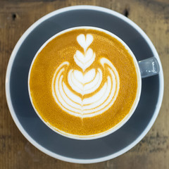 Latte art by a professional barista from a top-down view.