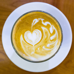 Latte art by a professional barista from a top-down view.