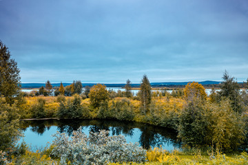 Lake Shore in autumn morning. Beautiful idyllic autumn nature. Rovaniemi, Finland.