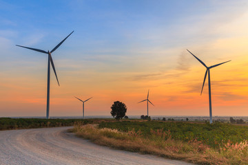 Wind turbine power generator farm at sunset