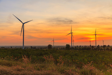 Wind turbine power generator farm at sunset