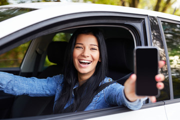 Happy woman showing mobile phone