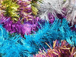 Multicolored shiny Christmas garland, festive tinsel background