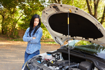 Angry woman with a broken car