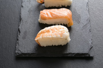 Pieces of sushi on a black stone