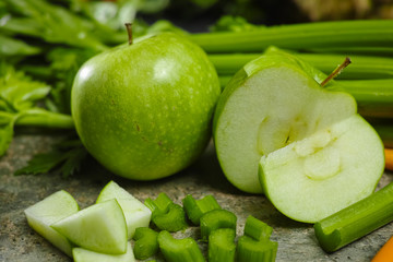Green vegetables and fruits -  celery shoots and  apples, dietary fitness concept