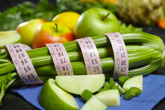 Green vegetables and fruits -  celery shoots and  apples, dietary fitness concept