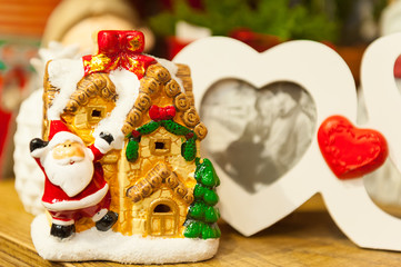 Two Heart shaped photo frame on wood tableAgainst the background of Christmas toys