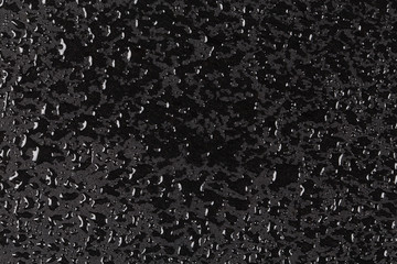 Water drops on dark stone surface
