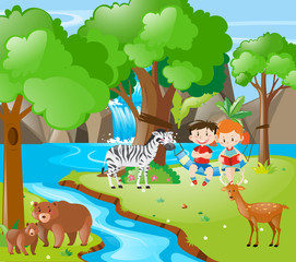 Kids and animals by the river