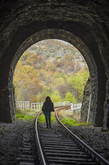Railway stone tunnel and woman inside