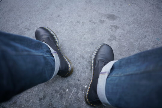 Jeans & Work Boots On Asphalt