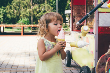 Little girl playing with a toy ice cream.