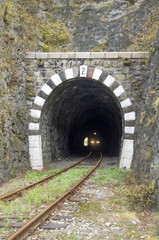 Fototapeta na wymiar Lights on the train in railway stone tunnel
