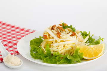 Waldorf Salad with green apples, celery and walnuts on a white plate