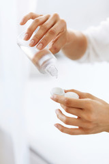 Woman Hands Putting Liquid From Bottle To Lens Box