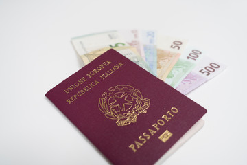 Italian passport with euro banknotes of 5, 10, 20, 50, 100 and 200 EUR denominations on white background