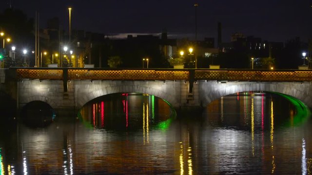 The bridge on the city of Dublin taken during the night with the color lights on the bridge in Ireland
