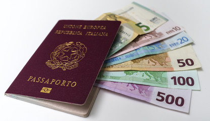 Italian passport with euro banknotes of 5, 10, 20, 50, 100 and 200 EUR denominations on white background