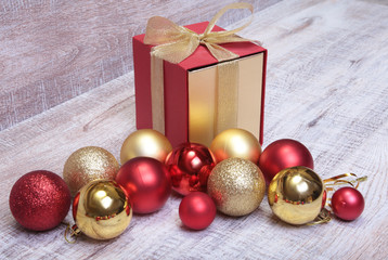 Gift boxes with many christmas balls on wood background