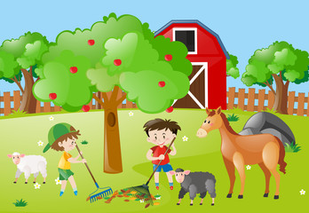 Obraz na płótnie Canvas Farm scene with boys raking leaves