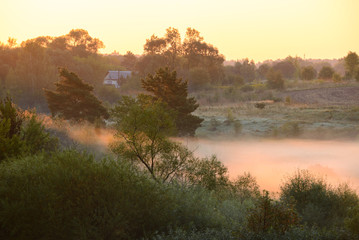 Foggy sunrise on the banks of a river in Polesie