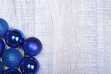 Blue christmas balls on a wooden background