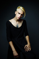 handsome young blond man. Male beauty concept. Portrait of fashionable young man with stylish haircut, on gray background. Perfect hair & skin. Hipster style.