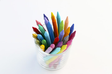 crayons in a transparent glass