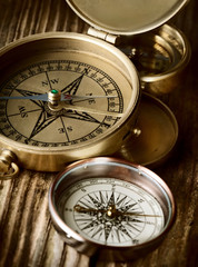 Fototapeta na wymiar antique compasses on wooden background